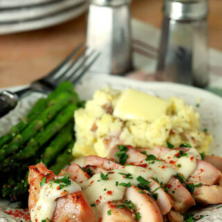 Buttermilk Roasted Chicken with Garlic and Brown Sugar on a White Plate with Mashed Potatoes and Asparagus