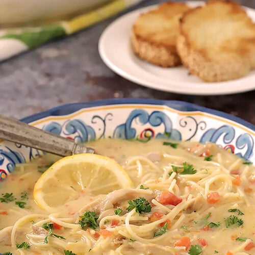 Bowl of Overhead of Greek Avgolemono Soup with Chicken and Lemon Soup Garnished with Parsley