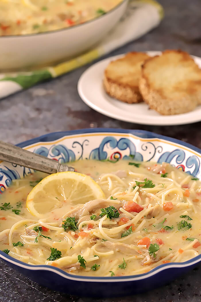 Bowl of Overhead of Greek Avgolemono Soup with Chicken and Lemon Soup Garnished with Parsley