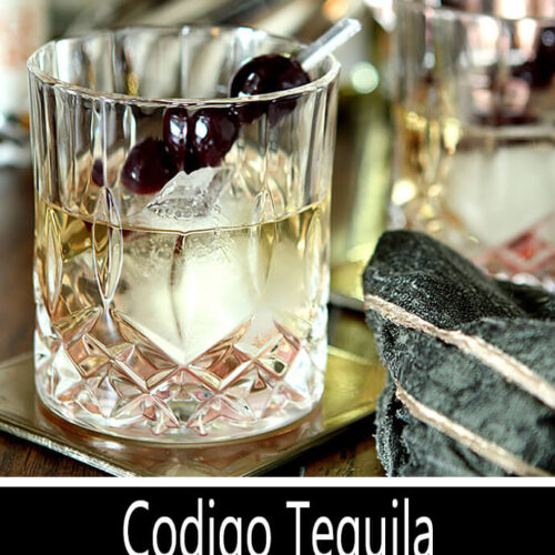 Codigo Tequila Manhattan Served in a Decorative Crystal Glass and Garnished with Burgundy Cherries