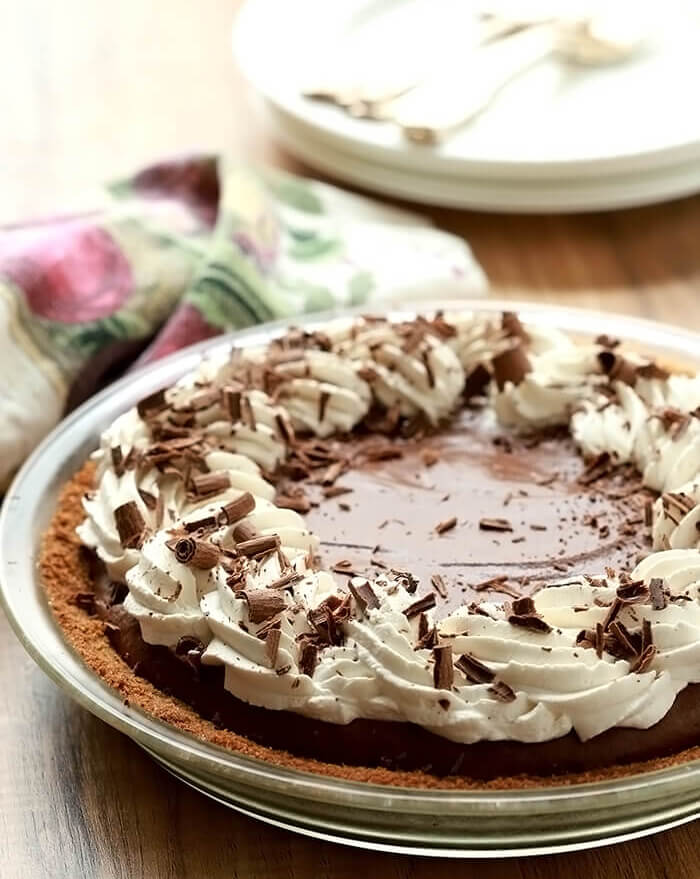 French Silk Pie with Bourbon topped with whipped cream and chocolate curls.