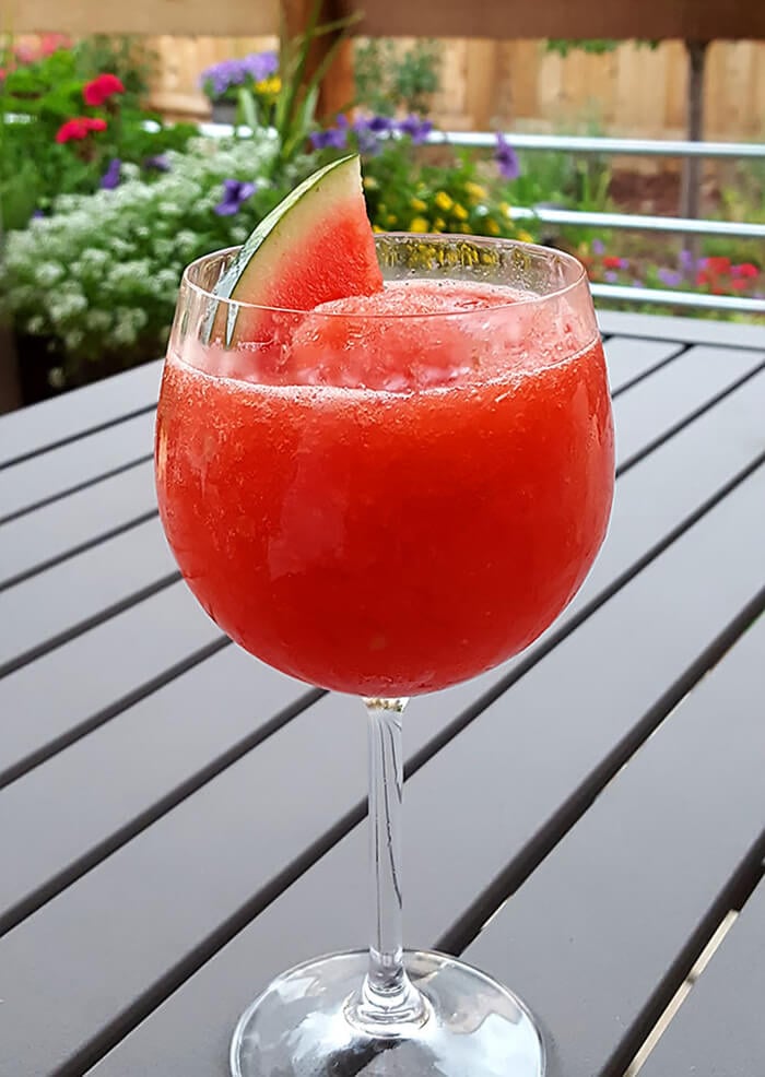 Fresh Watermelon Frosé in a Wine Glass and Garnished with a Watermelon Slice