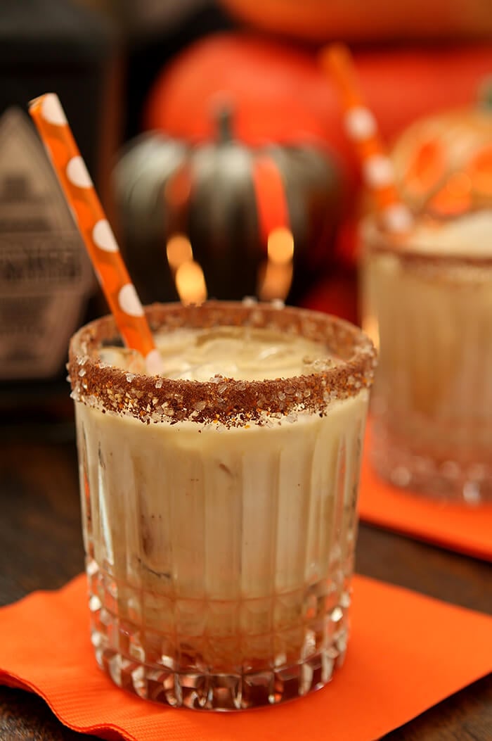 Best Halloween Cocktail Recipes - Tequila, Kahlua, and Cream Cocktail in a Highball Glass with an Orange Straw