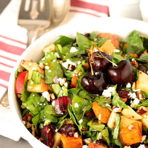 Sweet Potato and Spinach Salad with Pecans, Cherries and Goat Cheese in a Round White Serving Bowl