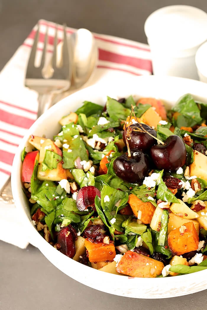 Sweet Potato and Spinach Salad with Pecans, Cherries and Goat Cheese in a Round White Serving Bowl