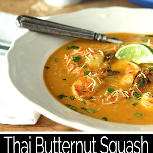 Thai Butternut Squash Soup with Shrimp Served in a White Bowl and Garnished with a Lime Wedge