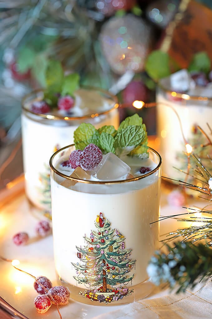 White Chocolate Mint Eggnog Cocktail Garnished with Mint Leaves and Sugared Cranberries