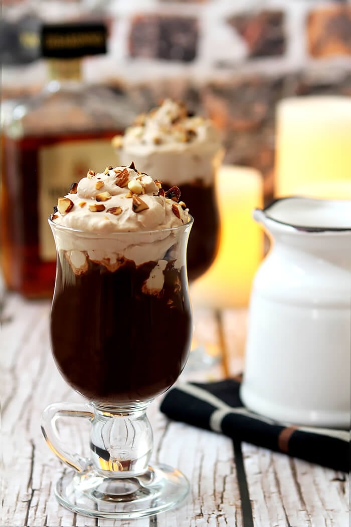 Amaretto Hot Chocolate in a Glass Mug with Whipped Cream and Toasted Almonds for Garnish