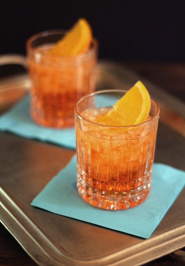 Pair of Aperol Spritz Cocktails served on turquoise napkins.