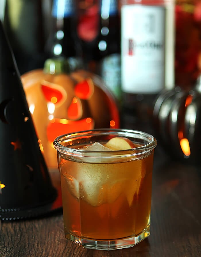 Apple Cider Cocktail with Vodka Served in a Highball Glass with Halloween Decor