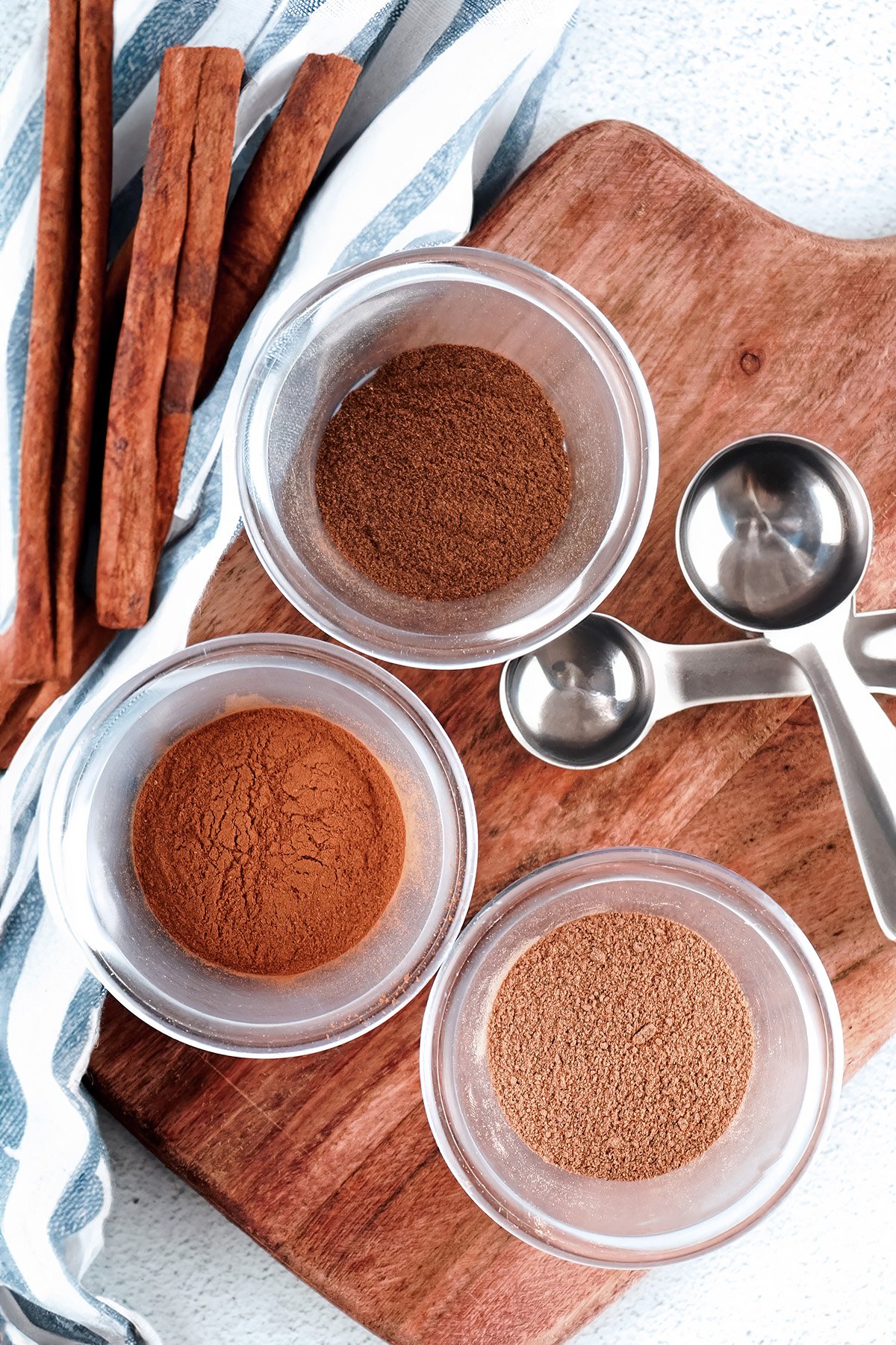 Cinnamon, Nutmeg, and Allspice in Separate Bowls