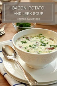 Bacon, Potato, and Leek Soup In White Bowl Garnished with Parsley