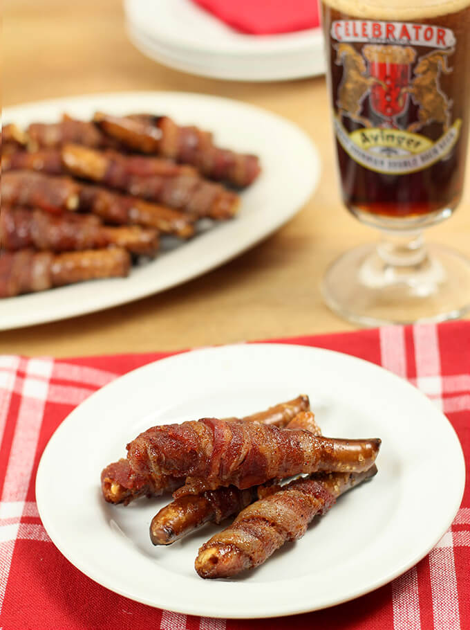 Bacon Wrapped Pretzel Rods Served with a Glass of Dark Beer.