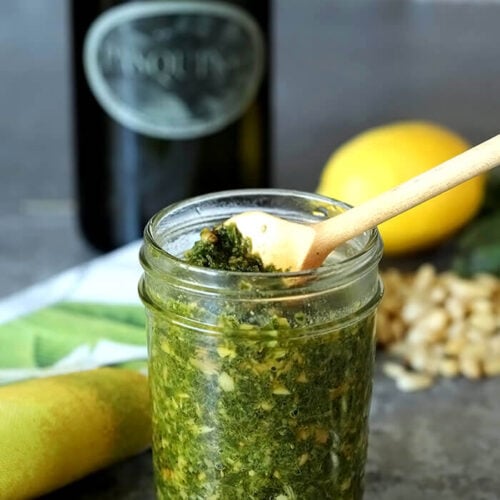 Traditional Italian Basil Pesto in a Small Jar with a Serving Spoon