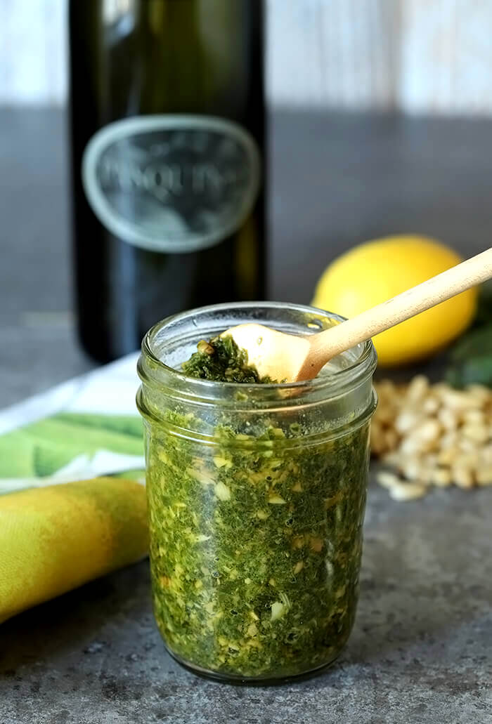 Italian Basil Pesto with Pine Nuts in a Small Jar with a Serving Spoon