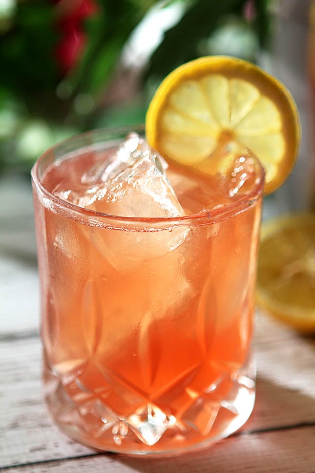 The Belmont Jewel Cocktail Served in a Glass with a Lemon Wheel Garnish