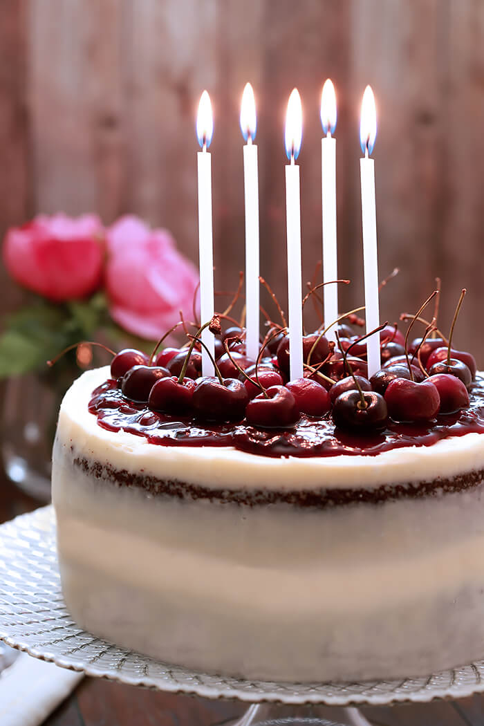 Black Forest Cake with Mascarpone Buttercream Frosting with Five White Candles