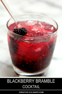 Blackberry Bramble Cocktail in Lowball Glass and Garnished with a Whole Blackberry