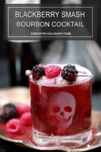 Sparkling Blackberry Smash Cocktail in Highball Glass with Etched Skull