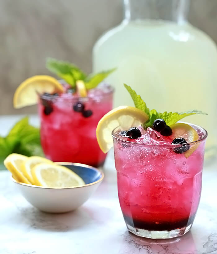 Sparkling Lemonade and Blueberry Cocktails Served with Lemon Slices and Mint