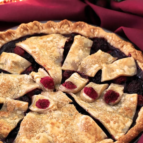 This Halloween Booberry Pie has Mixed Berries and a Design on Top with Pastry That Looks Like Fingers Grasping From Below