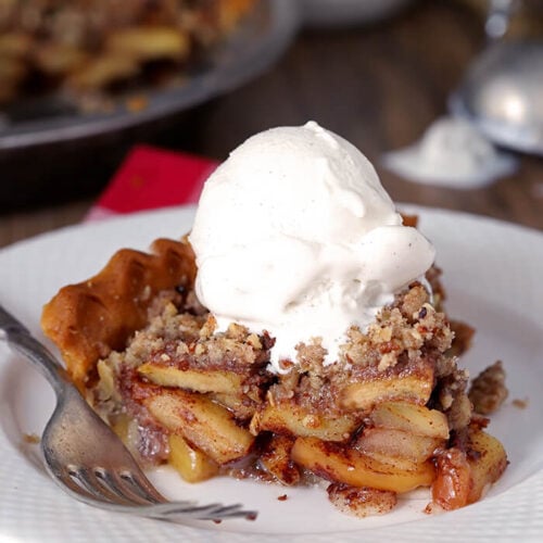 Closeup of Bourbon Caramel Apple Pie with Pecan Crumble with Vanilla Ice Cream