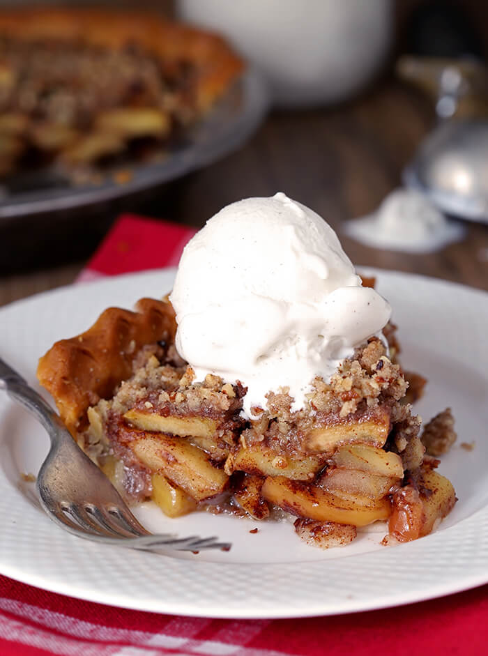 Closeup of Bourbon Caramel Apple Pie with Pecan Crumble with Vanilla Ice Cream