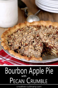 Whole Bourbon Caramel Apple Pie with Pecan Crumble with Slice Removed and Pint of Vanilla Ice Cream in Background