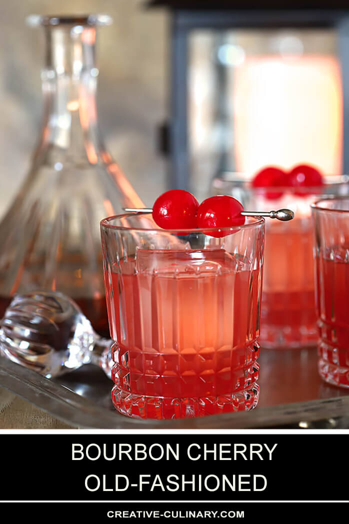 Bourbon Cherry Old Fashioned Cocktails with Maraschino Cherry Garnish in Setting with Cocktails and Decanter