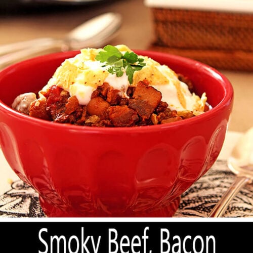 Smoky Beef, Bacon, and Bourbon Chili Served in a Red Bowl with Tortilla Chips and Sour Cream