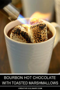 Bourbon Hot Chocolate with Toasted Marshmallow in a Cup Being Torched