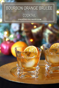 Two Bourbon Orange Brûlée Cocktails on Gold Serving Tray with Orange Garnish