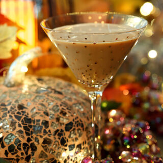 Bourbon Pumpkin Cocktail with Chocolate Liqueur Served in a Martini Glass with Gold Polk-a-dots