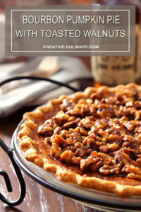 Whole Bourbon Pumpkin Pie with Toasted Walnuts in a White Pie Plate with Wrought Iron Holder