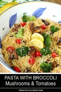 Pasta with Broccoli, Tomato, Mushrooms, and Parmesan Cheese in a Large White, Blue and Yellow Pasta Bowl