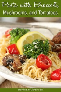 Closeup of Pasta with Broccoli, Tomato, Mushrooms, and Parmesan Cheese