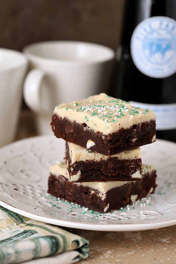 Stack of Three Guinness Stout Brownies with Irish Cream Frosting on a Square Plate