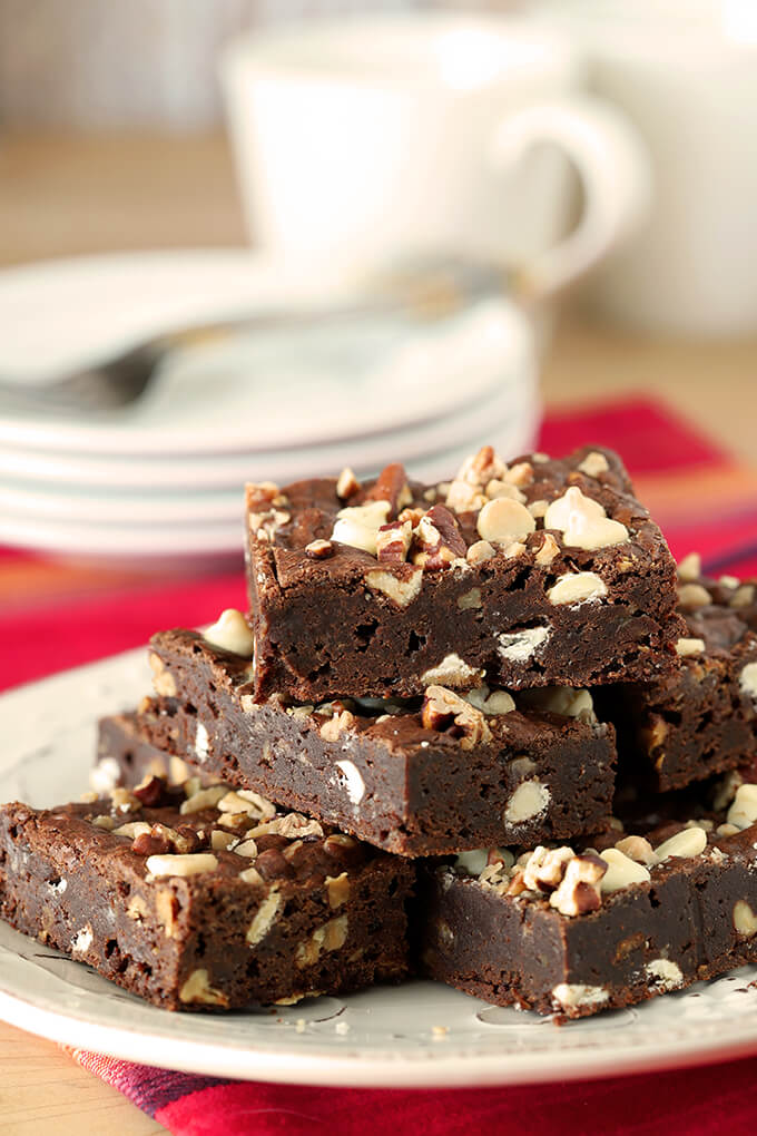 Gooey Brownies with Toasted Pecans and White Chocolate Chips Stacked on a Plate