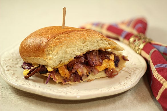 Hot Slaw, Bacon and Cheese Sandwich on a White Plate