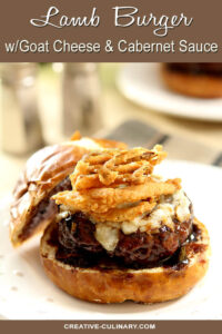 Lamb Burger with Goat Cheese and Cabernet Wine Sauce Topped with Fried Onion Rings and Served on a Bun