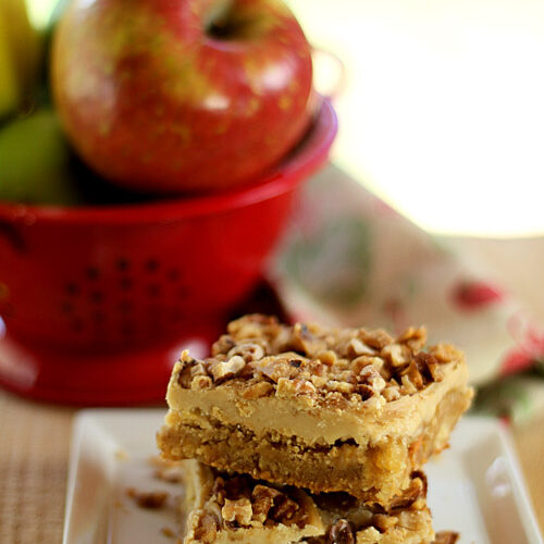 Toffee Apple Bars with Caramal Frosting SErved on a Plate with Apple in Background