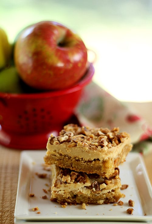 Toffee Apple Bars with Caramal Frosting SErved on a Plate with Apple in Background