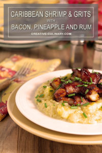 Caribbean Shrimp and Grits Served in a White Bowl with Rum Barbecue Sauce and Garnished with Chives