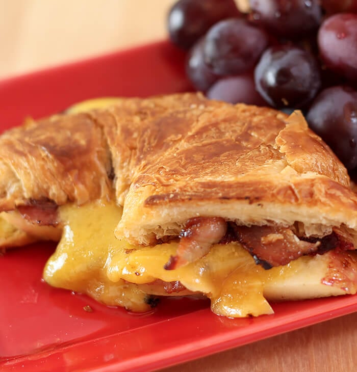 Cheddar, Pancetta, and Apple Grilled Cheese on Croissant Served with Dark Grapes