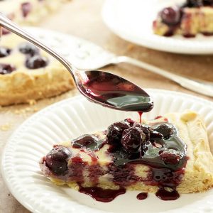 Cherry Ricotta Crostata Served on a White Plate with Port Cherry Sauce