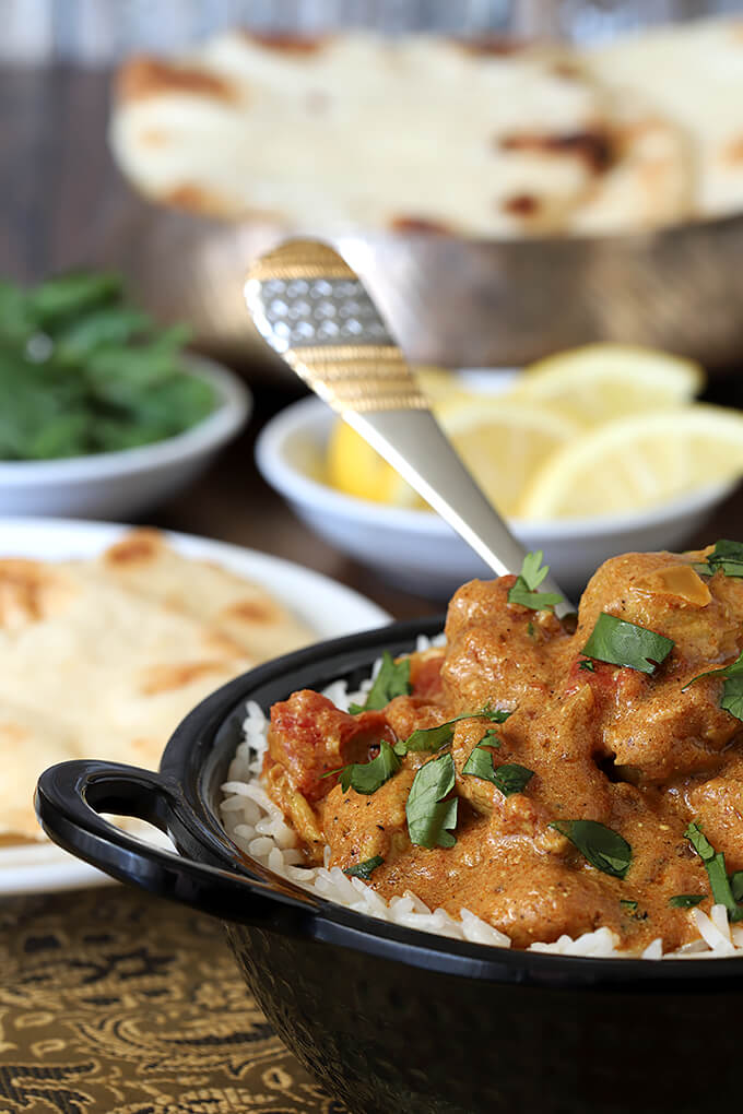 Easy Chicken Curry Served in Black Bowl with Lemon Garnish