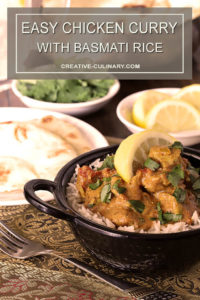 Easy Chicken Curry in Bowl and Table filled with Bread and Condiments