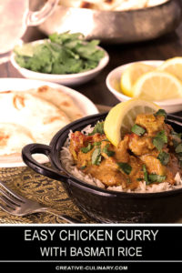 Easy Chicken Curry in Bowl and Table filled with Bread and Condiments