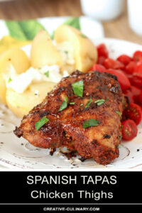 Spanish Tapas Chicken Thighs Garnished with Parsley and Served with Potatoes and Garlic Aioli with Cherry Tomatoes