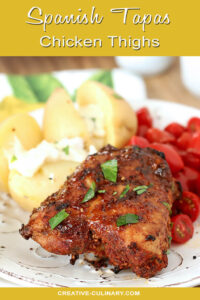 Spanish Tapas Chicken Thighs Garnished with Parsley and Served with Potatoes and Garlic Aioli with Cherry Tomatoes